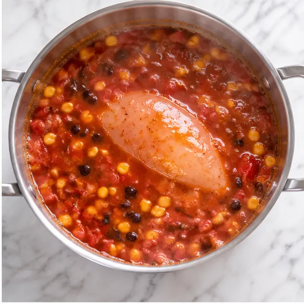 Step 2: Simmering soup with chicken fillet, enchilada sauce, and beans