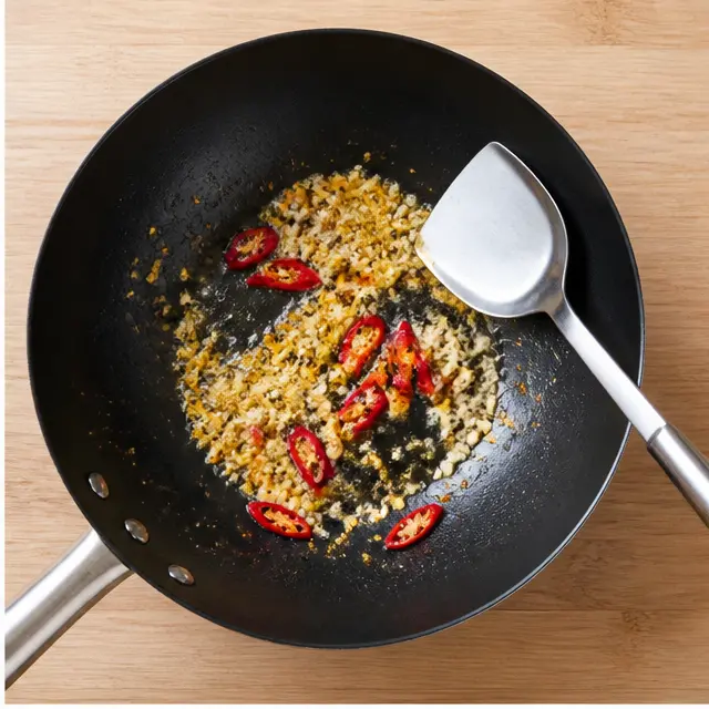 Blooming garlic, ginger, and chili in hot oil