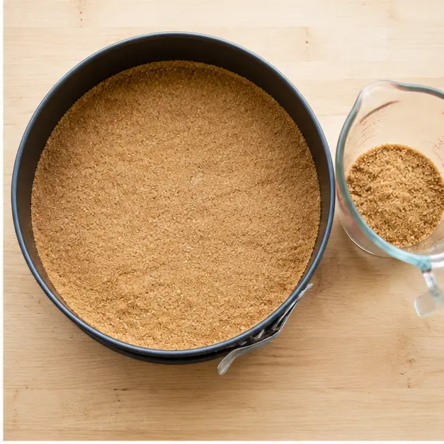 Press the graham cracker crust into the springform pan