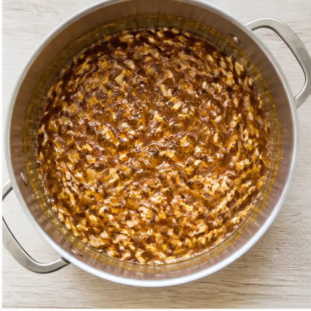 Step 2: Stirring in almonds and caramelizing to a deep golden brown.