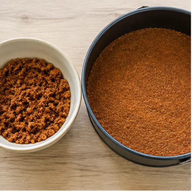Step 1: Press the gingersnap crumb mixture into the springform pan bottom.