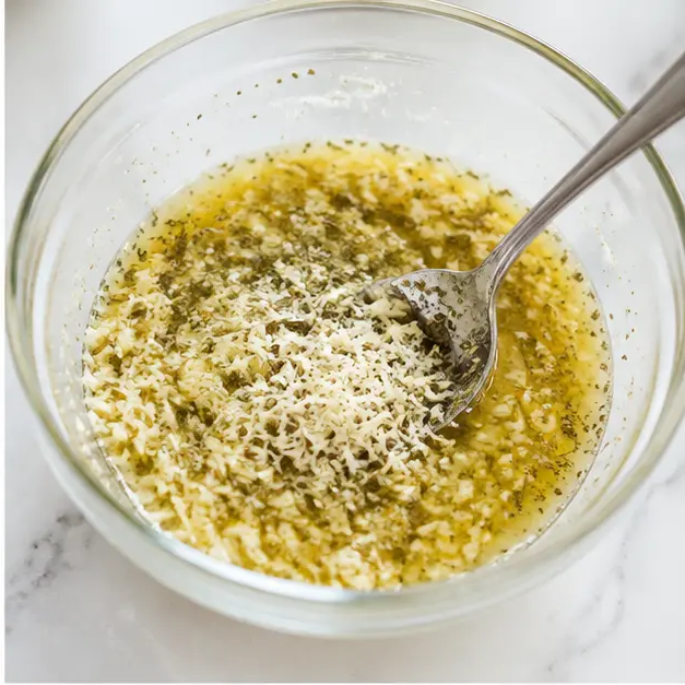Step 2: Stirring the garlic parmesan coating mixture together in a bowl