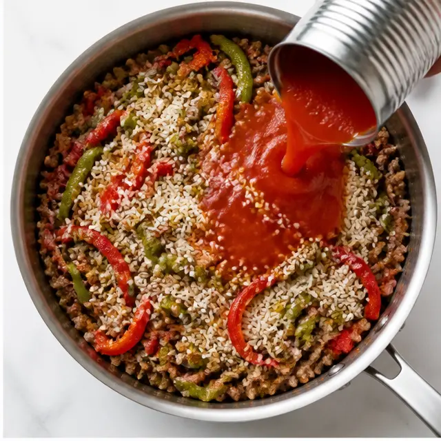 Adding taco seasoning, tomato sauce, rice, bell peppers, and broth