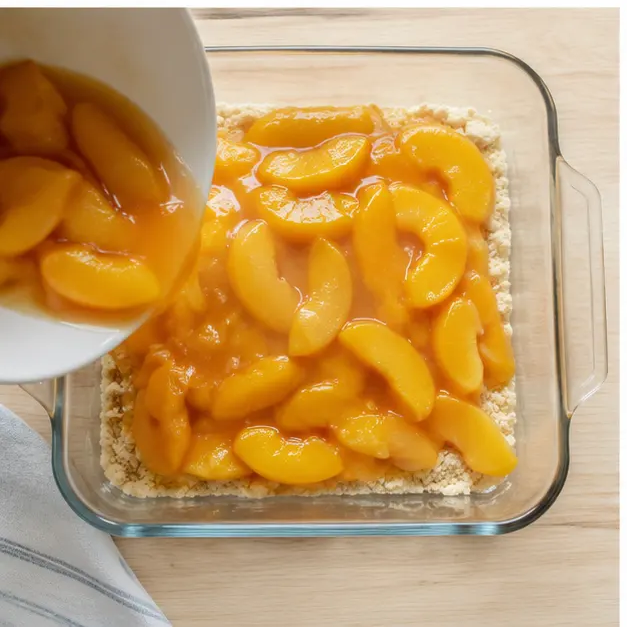 Step 3: Pour peaches with all their syrup over the bottom crumb layer