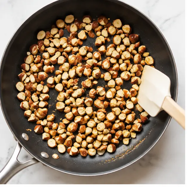 Step 1: Toasting chopped California almonds in a hot skillet until fragrant